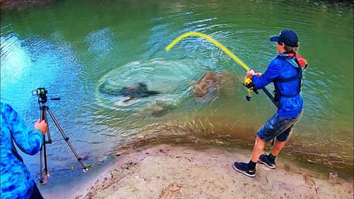 ITS GONNA PULL HIM IN!! (MONSTER CREEK FISH)