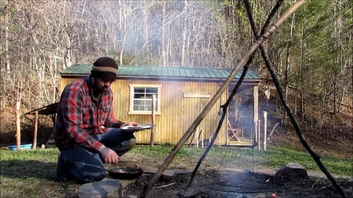 Building log fence around Cabin, beautiful day, cooking over fire